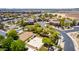 An aerial view of a community with manicured landscapes, sidewalks, and recreational facilities like a volleyball and basketball court at 343 N 169Th Ave, Goodyear, AZ 85338