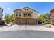 A two-story home featuring a balcony, three-car garage, and an inviting exterior with stucco and stone accents at 343 N 169Th Ave, Goodyear, AZ 85338
