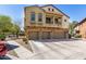 This two-story home features a balcony, three-car garage, and an inviting exterior with stucco and stone accents at 343 N 169Th Ave, Goodyear, AZ 85338