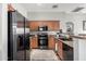Contemporary kitchen featuring stainless steel appliances, wooden cabinets, and modern fixtures at 343 N 169Th Ave, Goodyear, AZ 85338