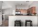Well-equipped kitchen with stainless steel appliances, ample counter space, and cozy breakfast bar at 343 N 169Th Ave, Goodyear, AZ 85338