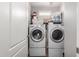 Efficient laundry room with side-by-side washer and dryer, offering convenience for household tasks at 343 N 169Th Ave, Goodyear, AZ 85338