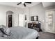 A spacious main bedroom with a TV, closet, and natural light from a window at 343 N 169Th Ave, Goodyear, AZ 85338