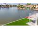 Beautiful lakefront property featuring a well-maintained lawn, private dock, and serene water views at 3520 N 110Th Ave, Avondale, AZ 85392