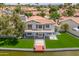 A waterfront home featuring a well-manicured lawn and a private dock, perfect for lakeside living at 3520 N 110Th Ave, Avondale, AZ 85392