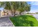 Backyard with lawn, mature trees, and waterfront access at 3520 N 110Th Ave, Avondale, AZ 85392