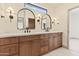 Bathroom with double sink vanity and dark-colored arched mirrors at 3520 N 110Th Ave, Avondale, AZ 85392