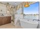 Luxurious bathroom boasts marble walls, soaking tub, and lake views at 3520 N 110Th Ave, Avondale, AZ 85392