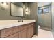 Modern bathroom showcases a sleek vanity with quartz countertop, stylish fixtures, and a glass-enclosed shower at 3520 N 110Th Ave, Avondale, AZ 85392