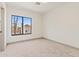 Bright bedroom featuring a large window offering neighborhood views and neutral carpet at 3520 N 110Th Ave, Avondale, AZ 85392