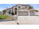 Two-story home featuring a three-car garage, tiled roof, and well-maintained landscaping at 3520 N 110Th Ave, Avondale, AZ 85392