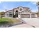 Two-story home featuring a three-car garage, tiled roof, and well-maintained landscaping at 3520 N 110Th Ave, Avondale, AZ 85392