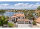 Waterfront home featuring a two-car garage, tile roof, and meticulously maintained landscaping at 3520 N 110Th Ave, Avondale, AZ 85392