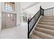 Bright entryway featuring arched windows, a staircase, and neutral color palette at 3520 N 110Th Ave, Avondale, AZ 85392