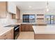 Modern kitchen with stainless appliances, island, and window views of the water at 3520 N 110Th Ave, Avondale, AZ 85392