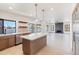 Modern kitchen with stainless appliances, island, and views of the waterfront at 3520 N 110Th Ave, Avondale, AZ 85392