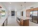 Open-concept kitchen boasts a large island with quartz countertops, stainless steel appliances, and custom cabinets at 3520 N 110Th Ave, Avondale, AZ 85392