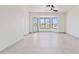 Bright living room showcasing scenic lake views from expansive bay windows, modern ceiling fan, and tile floors at 3520 N 110Th Ave, Avondale, AZ 85392