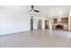Expansive living area with an open floor plan adjacent to the kitchen, a modern ceiling fan, and tile floors at 3520 N 110Th Ave, Avondale, AZ 85392