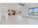 Open living space flows to the kitchen, featuring large windows with scenic lake views and new floors at 3520 N 110Th Ave, Avondale, AZ 85392