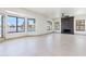 Spacious living room features a modern fireplace, large windows with lake views and new tile floors at 3520 N 110Th Ave, Avondale, AZ 85392
