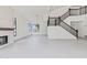 Bright, open living room with stone fireplace and staircase with dark wood railing at 3520 N 110Th Ave, Avondale, AZ 85392
