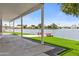 Covered patio featuring waterfront access with a lawn and small dock at 3520 N 110Th Ave, Avondale, AZ 85392