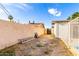 Spacious backyard area features a gravel area and a partially walled section, along with healthy plants at 3733 W Flynn Ln, Phoenix, AZ 85019