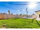 Open backyard featuring healthy lawn with a partially fenced pool area at 3733 W Flynn Ln, Phoenix, AZ 85019