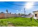 Lush backyard with green lawn, framed by brick and white fencing, with sunny exposure at 3733 W Flynn Ln, Phoenix, AZ 85019