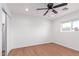 Well-lit bedroom featuring neutral walls, ceiling fan, and wood-look flooring at 3733 W Flynn Ln, Phoenix, AZ 85019
