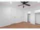 Spacious bedroom with ceiling fan, closet, and new wood-look flooring at 3733 W Flynn Ln, Phoenix, AZ 85019