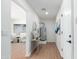 Hallway featuring wood floors, white walls, lighting, and an entrance into the living room at 3733 W Flynn Ln, Phoenix, AZ 85019