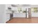 Bright kitchen with stainless steel appliances, white cabinets, and wood-look floors at 3733 W Flynn Ln, Phoenix, AZ 85019