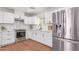 Modern kitchen features stainless steel appliances, white cabinets, and wood-look flooring at 3733 W Flynn Ln, Phoenix, AZ 85019