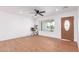 Bright, airy living room with wood floors and a view of the outdoors through a large window at 3733 W Flynn Ln, Phoenix, AZ 85019