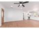 Bright living room with wood floors, ceiling fan, and open access to kitchen at 3733 W Flynn Ln, Phoenix, AZ 85019