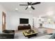 Bright living room with ceiling fan, wood floors, and open access to modern kitchen at 3733 W Flynn Ln, Phoenix, AZ 85019