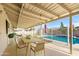 Covered patio with a dining table, chairs, and an outdoor view of the pool at 3733 W Flynn Ln, Phoenix, AZ 85019