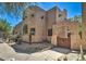 Stunning exterior with private wooden gated entrance, desert landscaping, and a beautiful adobe facade at 38065 N Cave Creek Rd # 9, Cave Creek, AZ 85331
