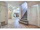 Welcoming foyer with tile flooring, staircase, neutral colors, and an open layout to the living space at 38065 N Cave Creek Rd # 9, Cave Creek, AZ 85331