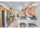 Well-equipped kitchen with stainless steel appliances, light wood cabinets, tile floors, and breakfast bar at 38065 N Cave Creek Rd # 9, Cave Creek, AZ 85331