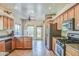 Open-concept kitchen featuring stainless steel appliances, light wood cabinetry, and tile floors at 38065 N Cave Creek Rd # 9, Cave Creek, AZ 85331