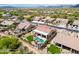 Gorgeous aerial view of a home with a private backyard featuring a pool, covered patio, and lush landscaping at 4607 E Sierra Sunset Trl, Cave Creek, AZ 85331