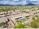 Scenic aerial view of a desert home with a private pool, patio, and lush landscaping against a mountain backdrop at 4607 E Sierra Sunset Trl, Cave Creek, AZ 85331