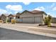 Inviting home featuring a well-kept front yard with desert landscaping and a spacious three-car garage at 4607 E Sierra Sunset Trl, Cave Creek, AZ 85331