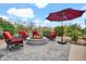 Paver patio with an outdoor firepit, an umbrella and comfortable seating at 4607 E Sierra Sunset Trl, Cave Creek, AZ 85331
