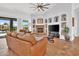 Elegant living room with a stone fireplace, built-in shelving, and hardwood floors at 4607 E Sierra Sunset Trl, Cave Creek, AZ 85331