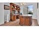 Well lit home office featuring custom desk and bookshelves with a view to the outside at 4607 E Sierra Sunset Trl, Cave Creek, AZ 85331