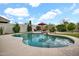 Sparkling backyard pool with a rock waterfall, mature trees, and desert landscaping at 4607 E Sierra Sunset Trl, Cave Creek, AZ 85331